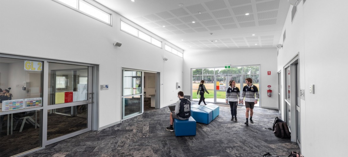Interior School Multipurpose Space with Glass Doors and Students