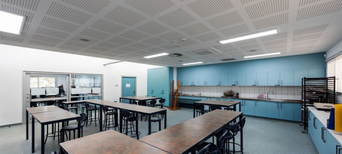 Interior Science Classroom with Desks, Chairs and Blue Cabinetry