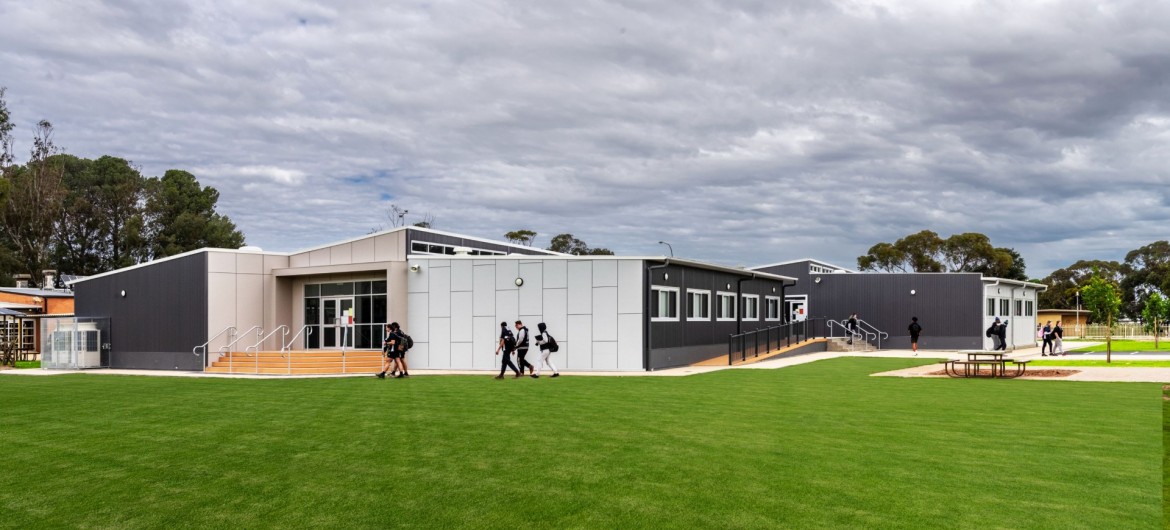 Exterior Modular School Building with White and Grey Panelling in Front of Lawn
