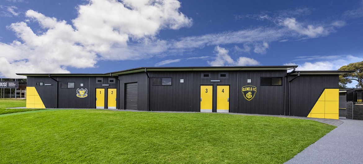 Exterior Sports Building with Corrugated Steel Cladding and Yellow Panelling and Doors