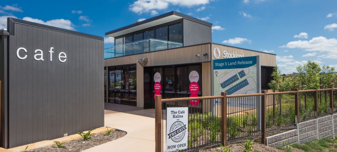 Exterior Modular Sales Office with Wooden Panelling and Stockland Signage