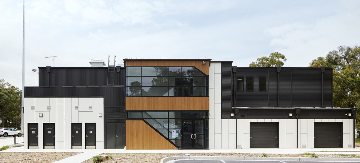 Modular Building with Black and White Panelling and Windows Facing Parking Lot